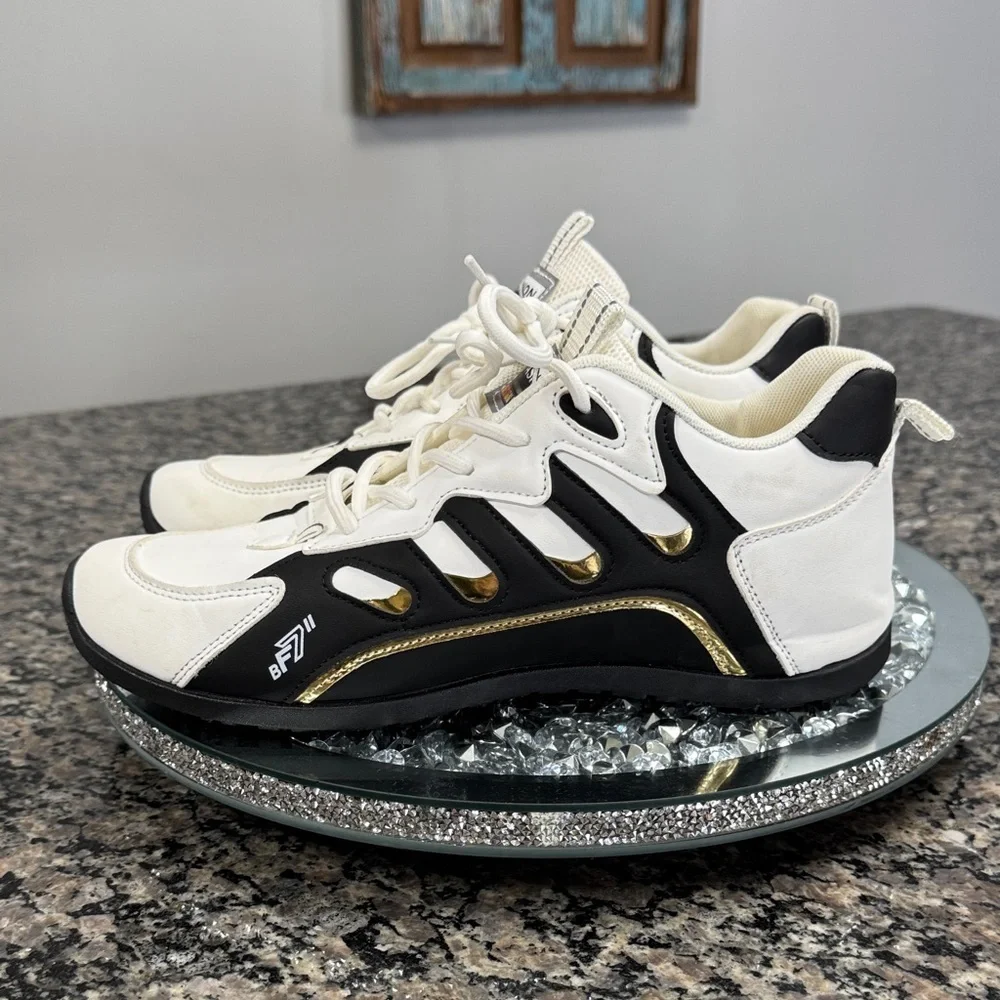 White and Black womens fashion Sneakers with gold accents EUC 10